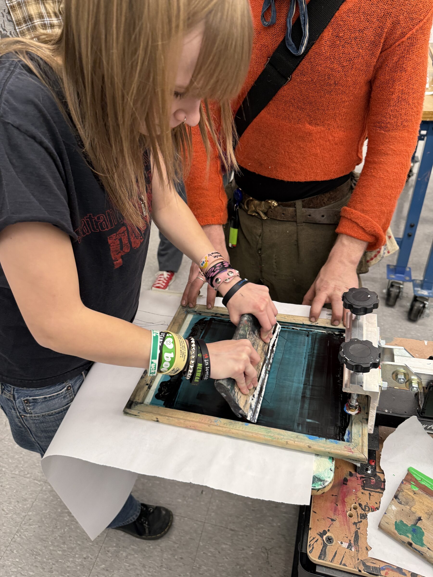 Close view of a student screenprinting