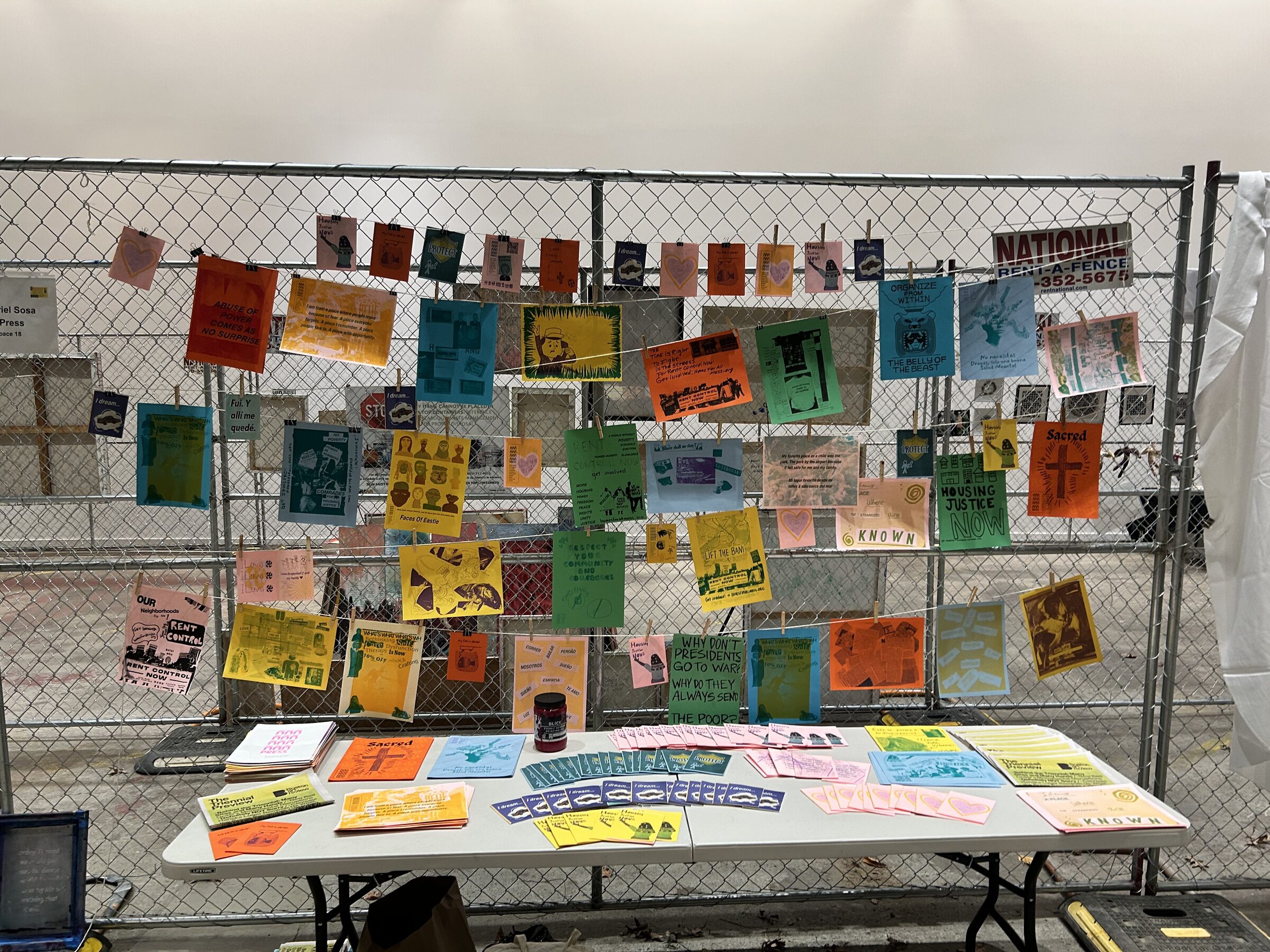 ñ press table and printed work displayed at the ICA Watershed