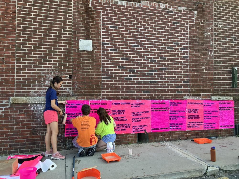 Wheatpasting the pink text installation at Atlantic Works Gallery