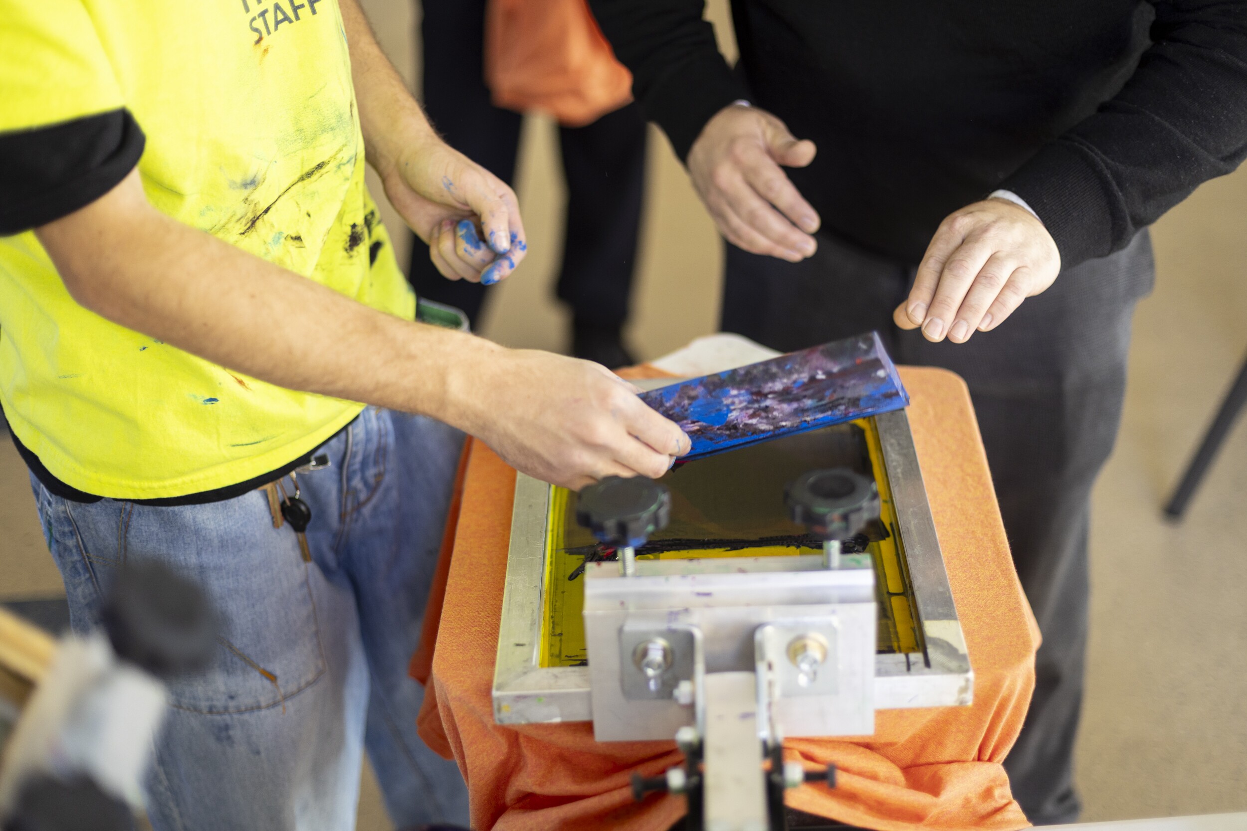 Hands preparing a screen for printing